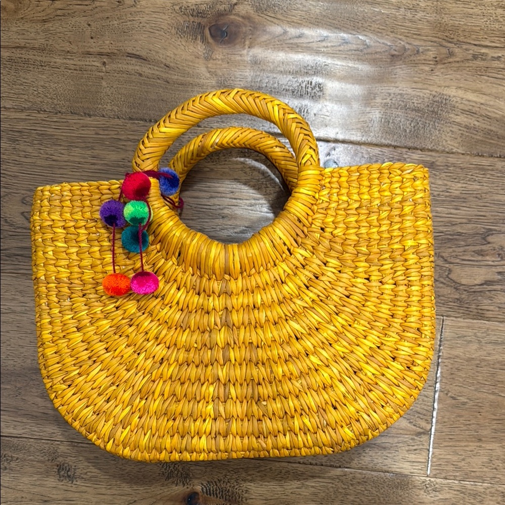 Vibrant Yellow Woven Handbag with Colorful Pom Poms